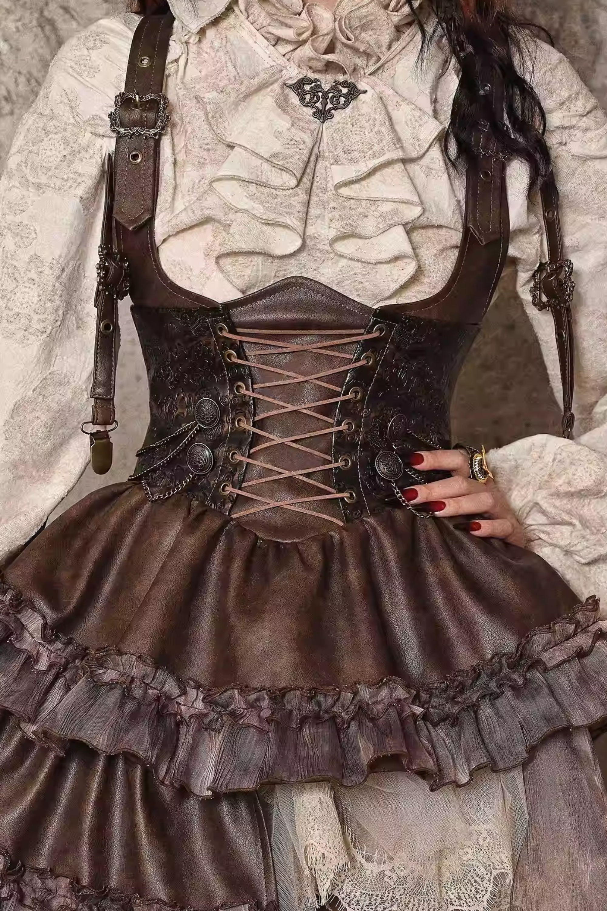 Steampunk-style outfit with brown corset and suspenders over a white lace garment.